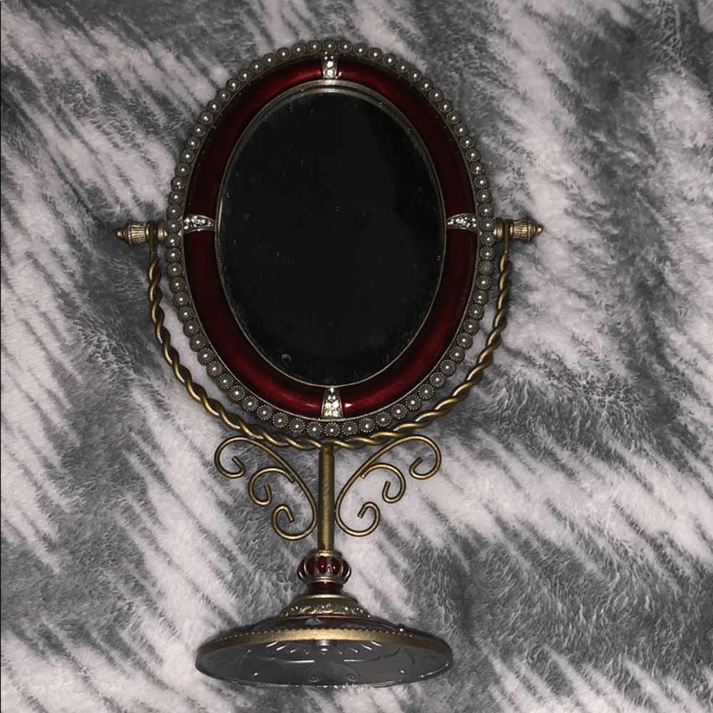 A vintage Rudy red and gold mirror